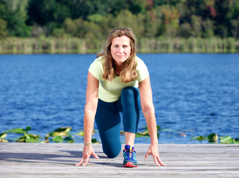 Fit Rx Performance's Debbie Ivie in a one-knee stretch in Winter Park, Florida.